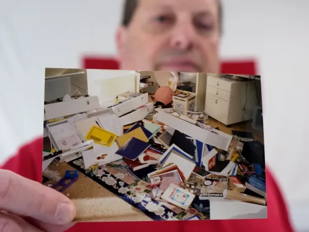 Red Cross volunteer Craig Renetzky holds a photograph of a bedroom in his condo in Reseda, nearly destroyed during the 1994 Northridge Earthquake. At the Sherman Oaks American Red Cross office on Thursday, Jan. 11, 2024.