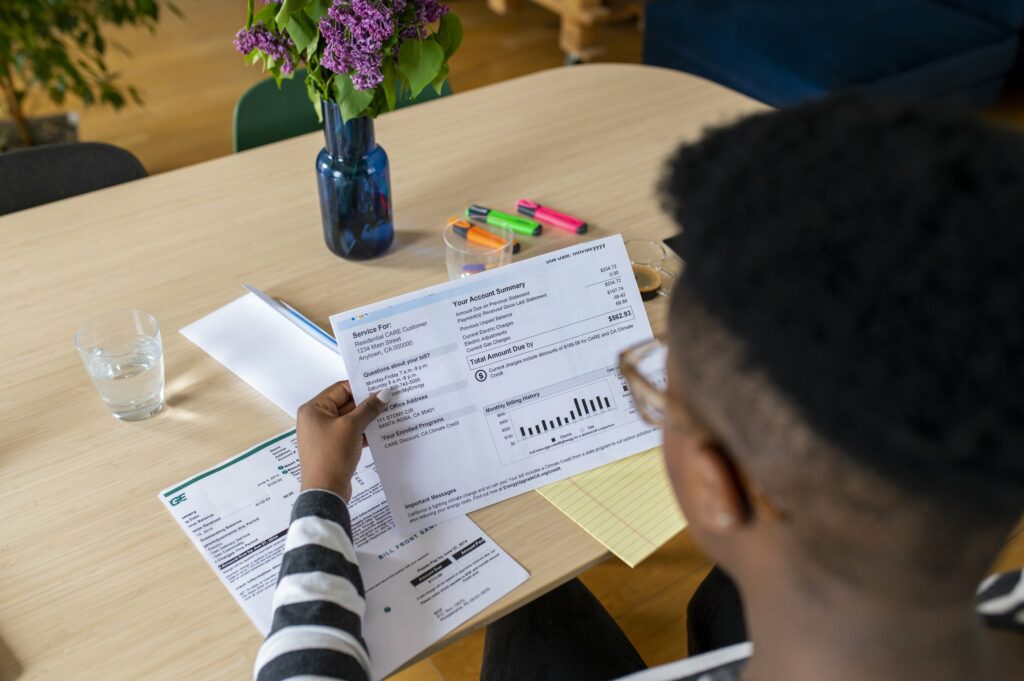 A young African American man looks at the electricity bill